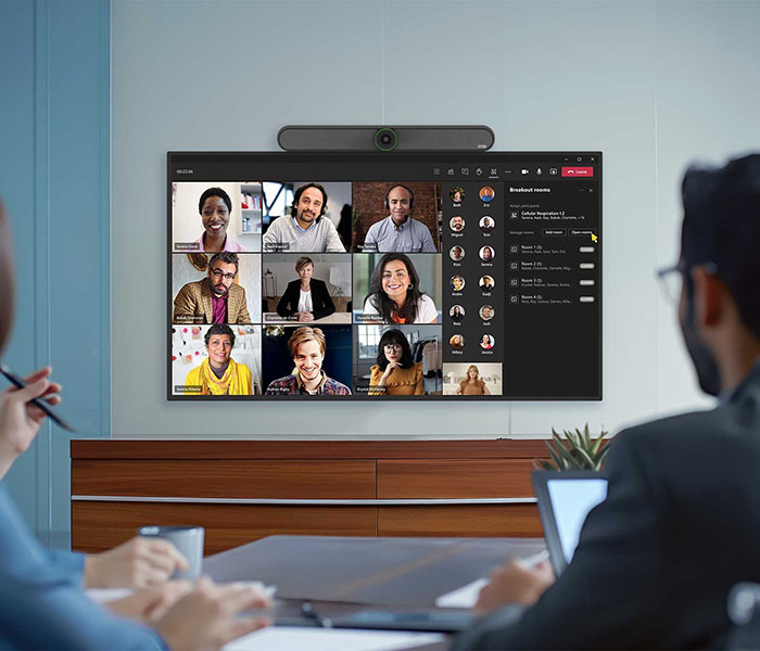 A group of individuals in an office participating in a video conference